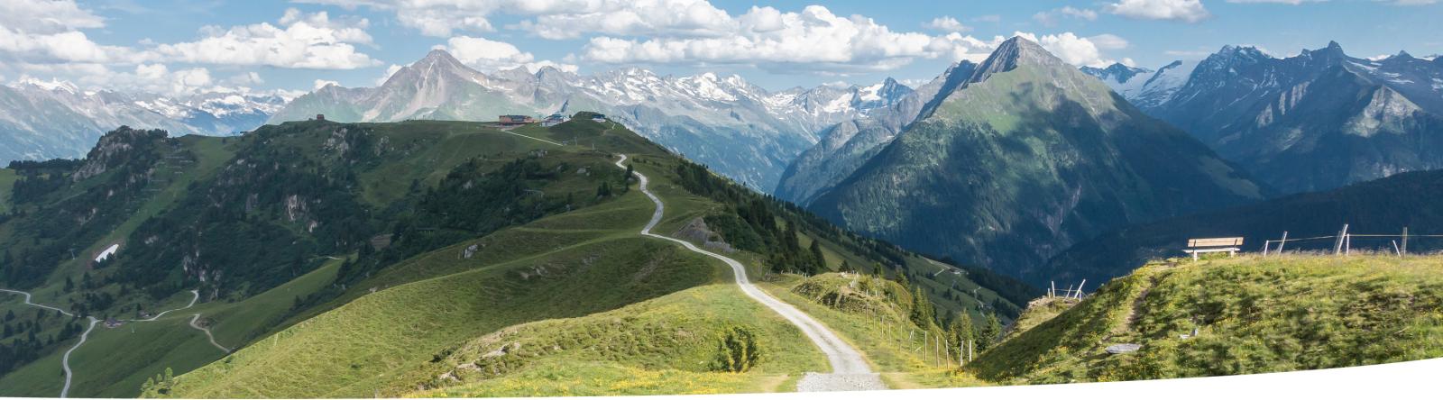 Path along a mountain ridge with a panoramic view.